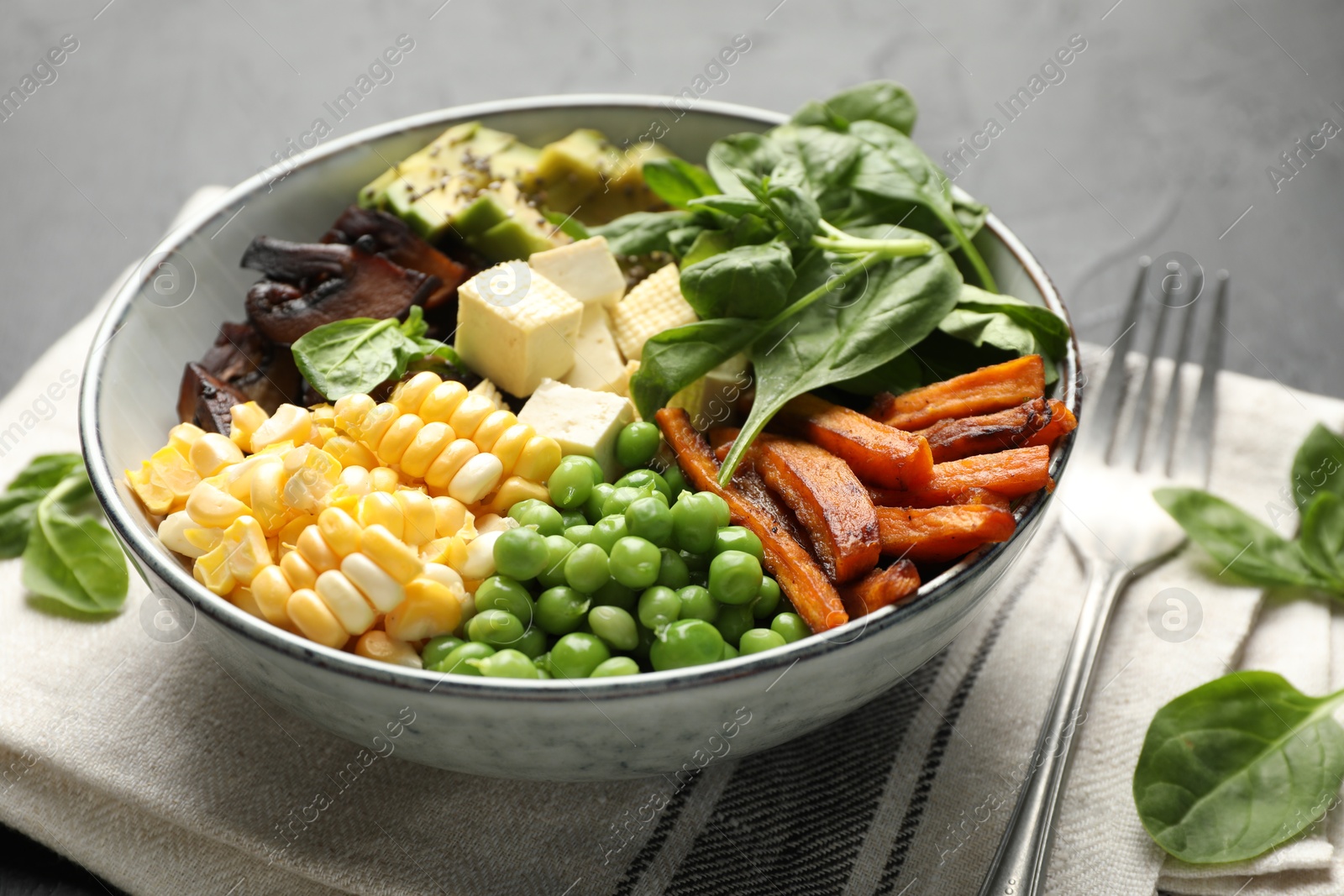 Healthy vegetarian food. Delicious Buddha bowl on black table, closeup Photo of Healthy vegetarian food. Delicious Buddha bowl on black table, closeup