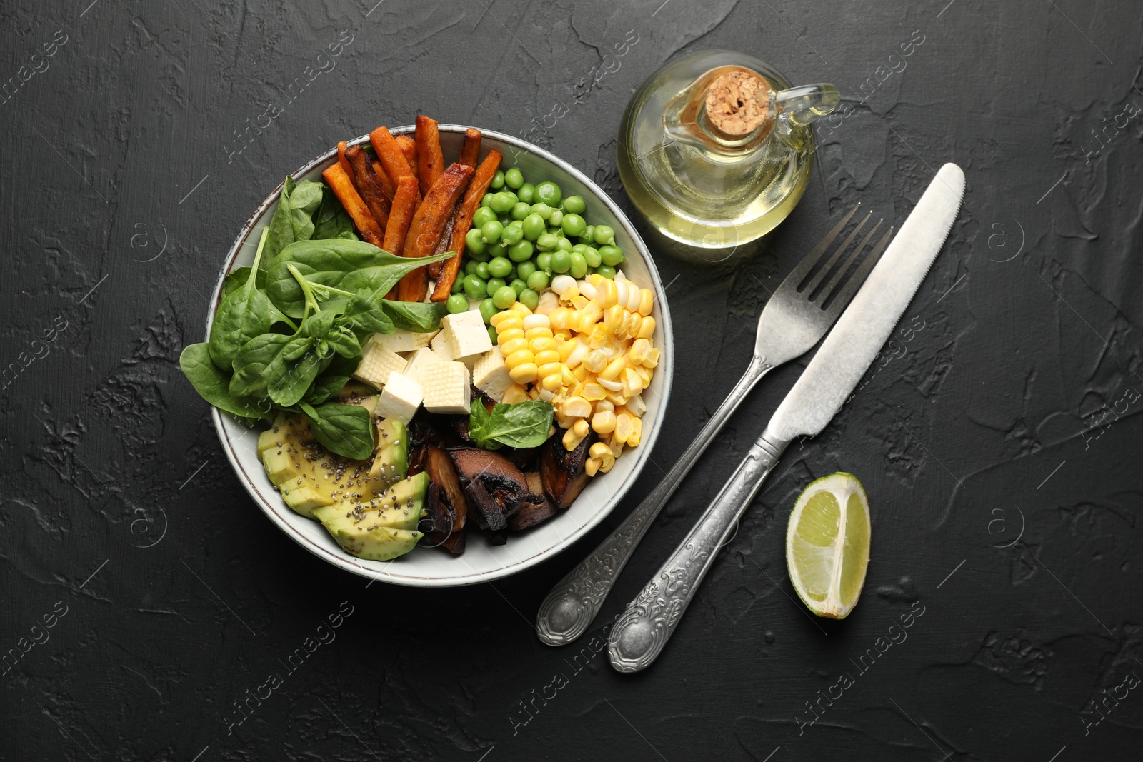 Photo of Healthy vegetarian food. Delicious Buddha bowl on black table, flat lay