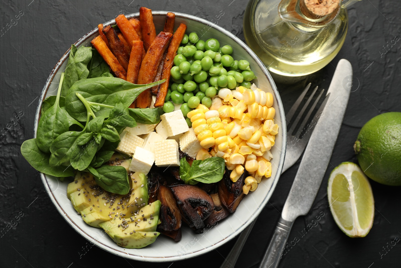 Healthy vegetarian food. Delicious Buddha bowl on black table, flat lay Photo of Healthy vegetarian food. Delicious Buddha bowl on black table, flat lay