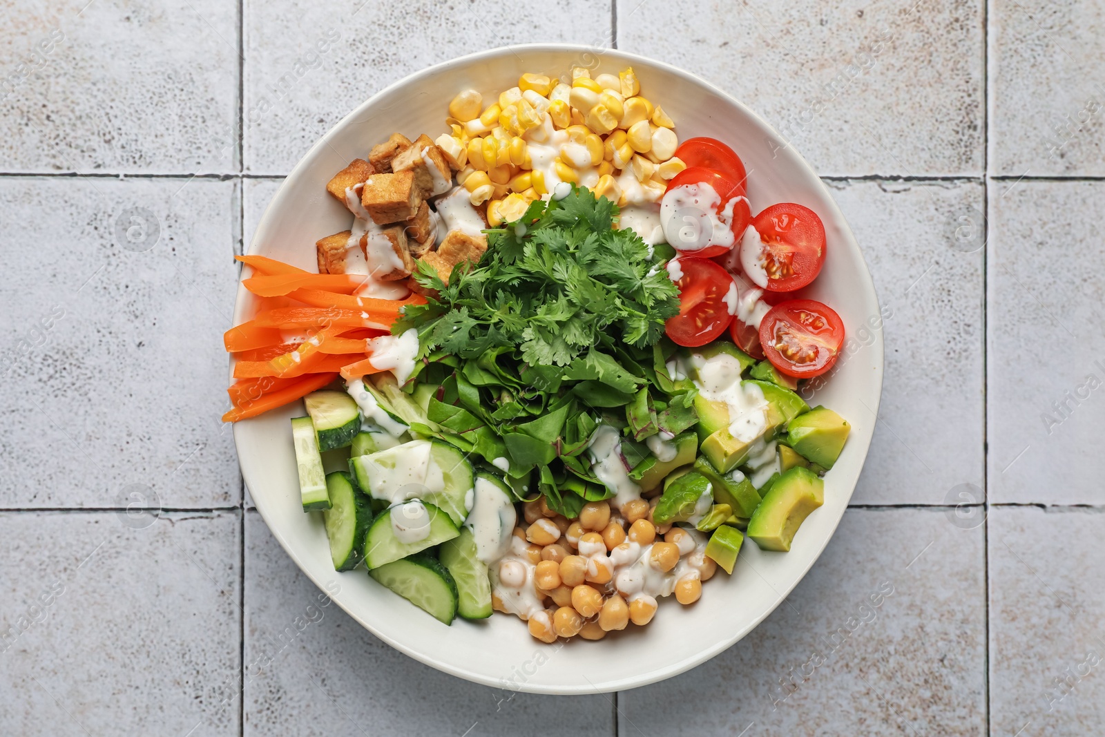 Different healthy vegetarian food on light tiled table, top view Photo of Different healthy vegetarian food on light tiled table, top view