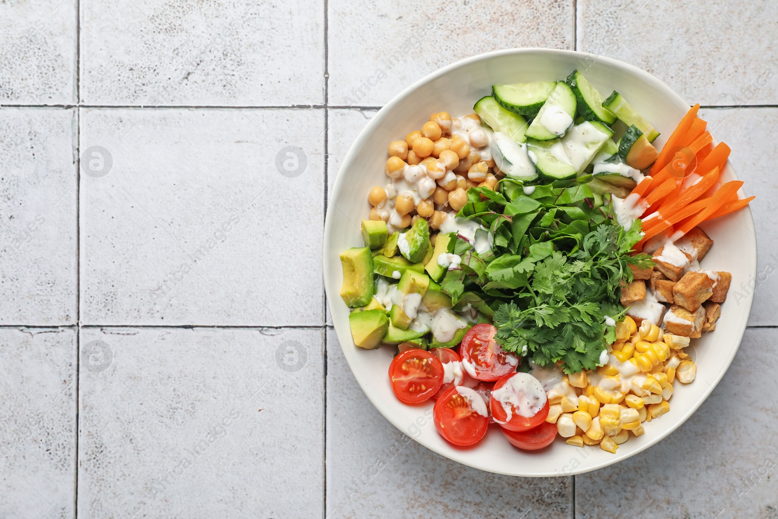 Different healthy vegetarian food on light tiled table, top view. Space for text Photo of Different healthy vegetarian food on light tiled table, top view. Space for text