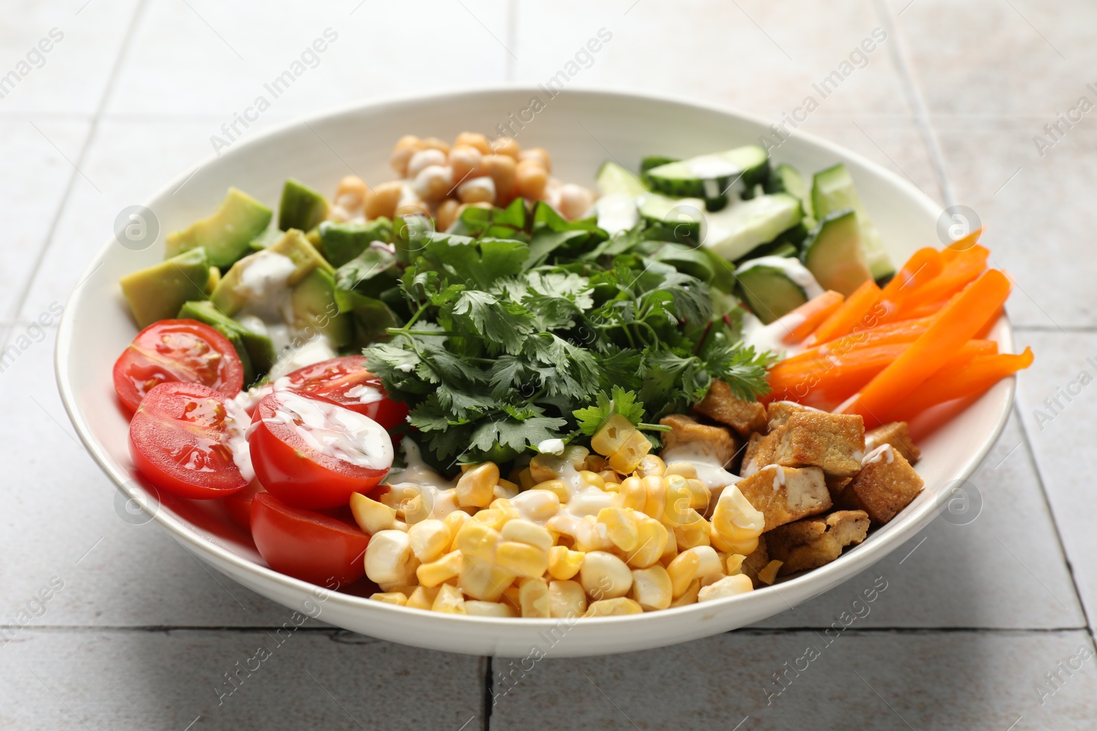 Different healthy vegetarian food on light tiled table, closeup Photo of Different healthy vegetarian food on light tiled table, closeup