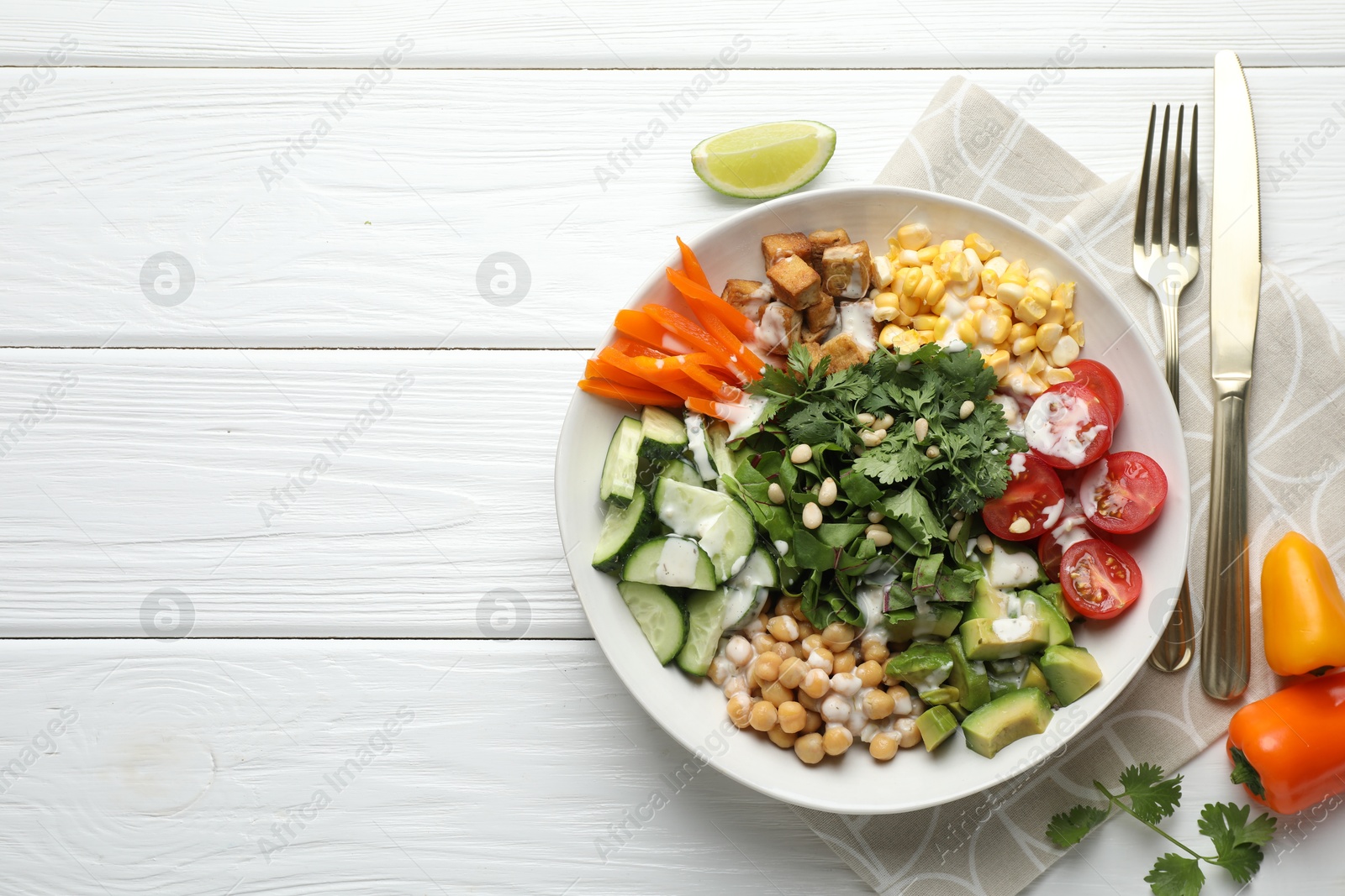 Different healthy vegetarian food served on white wooden table, flat lay. Space for text Photo of Different healthy vegetarian food served on white wooden table, flat lay. Space for text