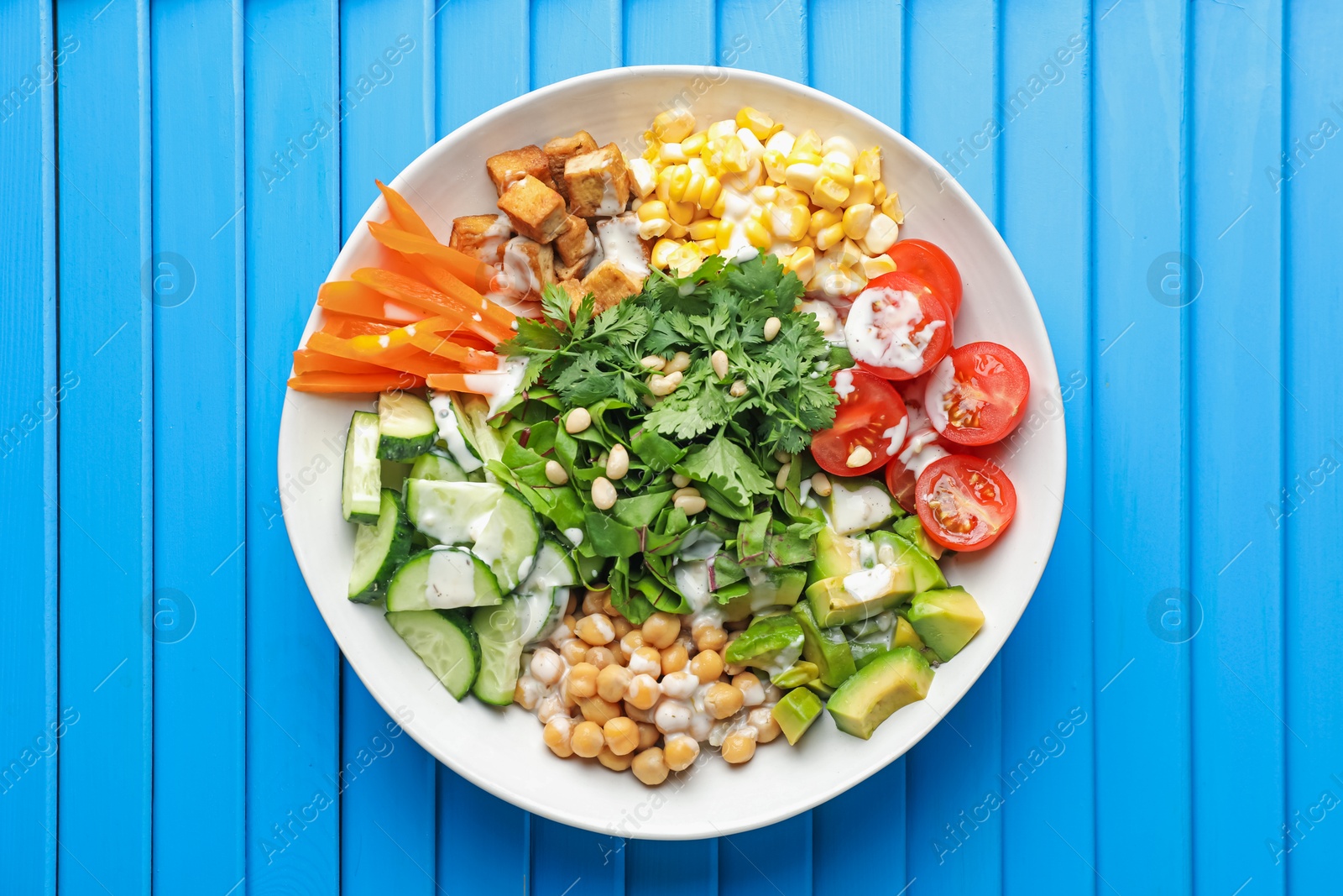 Different healthy vegetarian food on light blue wooden table, top view Photo of Different healthy vegetarian food on light blue wooden table, top view