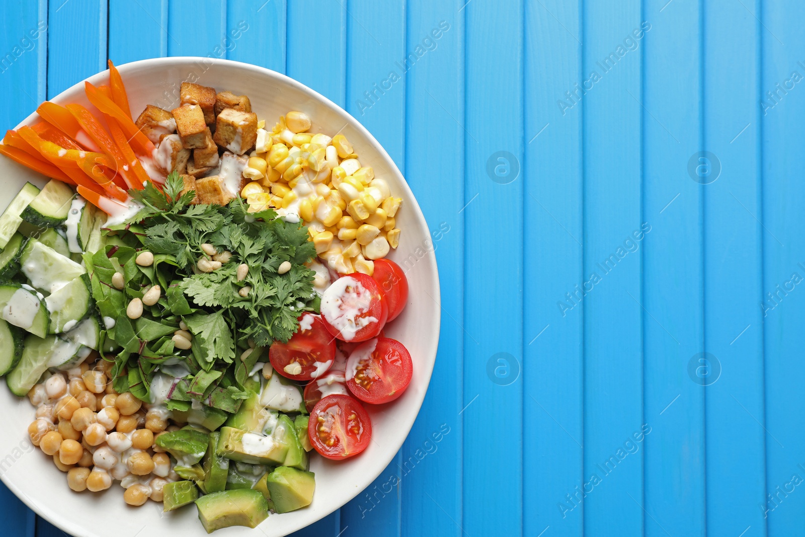Different healthy vegetarian food on light blue wooden table, top view. Space for text Photo of Different healthy vegetarian food on light blue wooden table, top view. Space for text