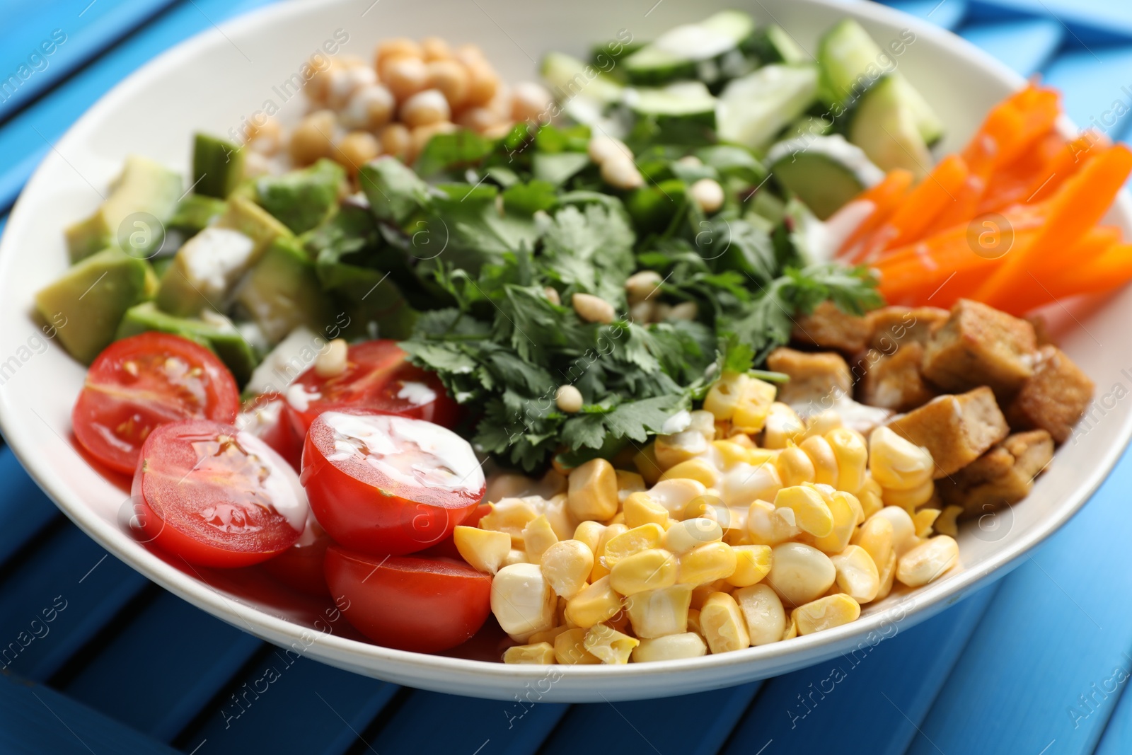 Different healthy vegetarian food on light blue wooden table, closeup Photo of Different healthy vegetarian food on light blue wooden table, closeup