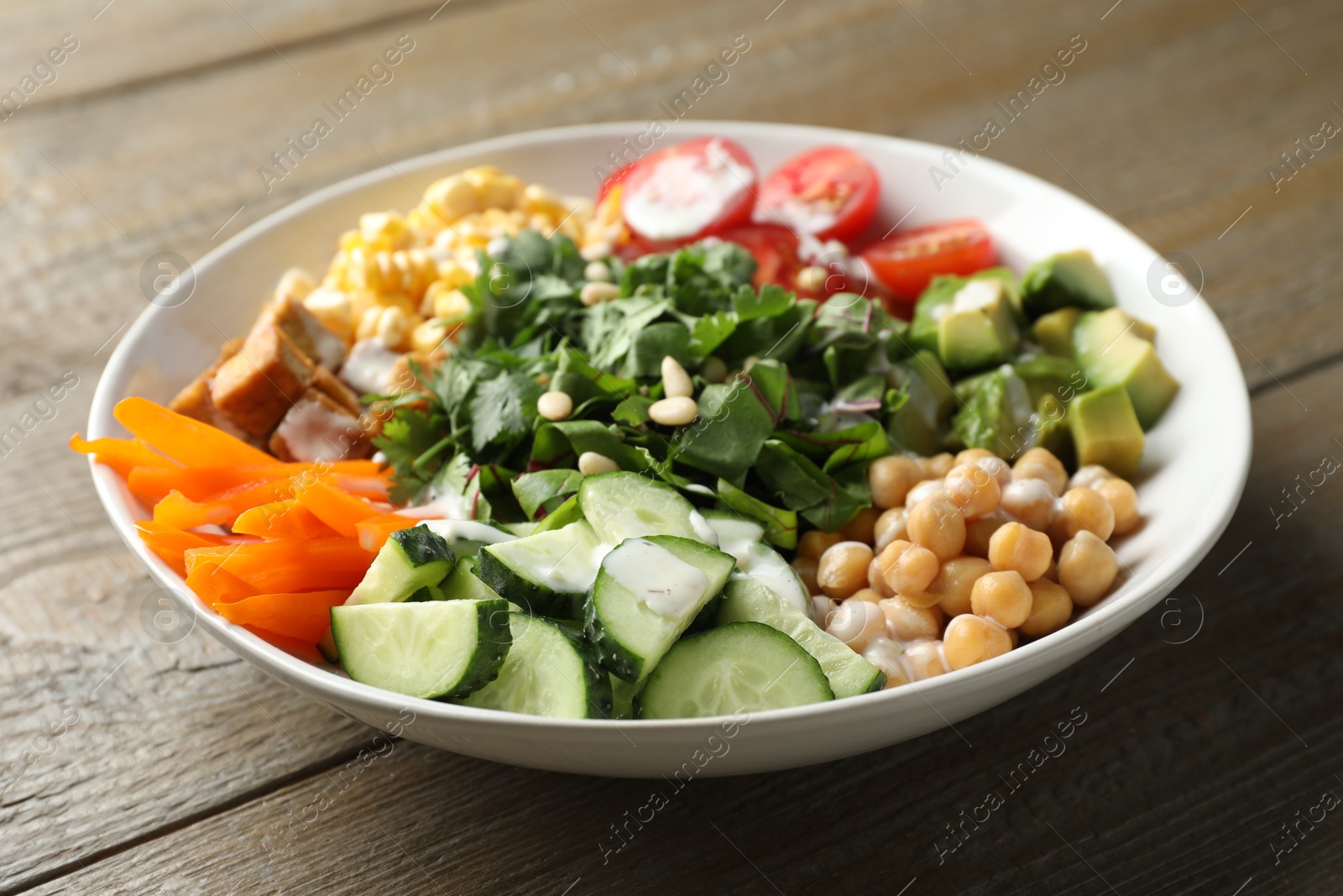 Different healthy vegetarian food on wooden table, closeup Photo of Different healthy vegetarian food on wooden table, closeup
