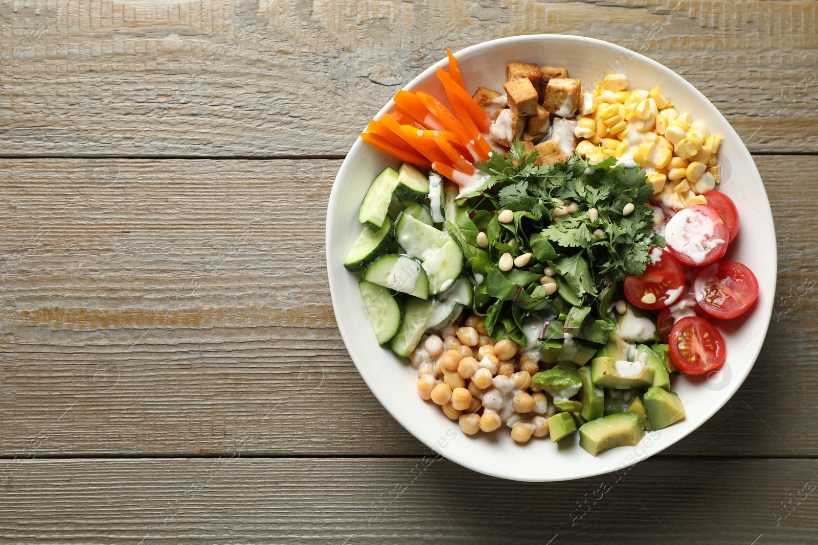 Different healthy vegetarian food on wooden table, top view. Space for text Photo of Different healthy vegetarian food on wooden table, top view. Space for text