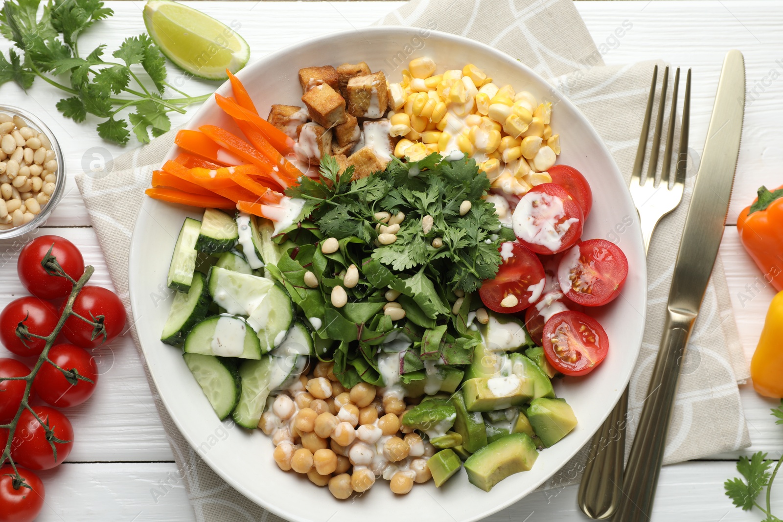 Different healthy vegetarian food served on white wooden table, flat lay Photo of Different healthy vegetarian food served on white wooden table, flat lay