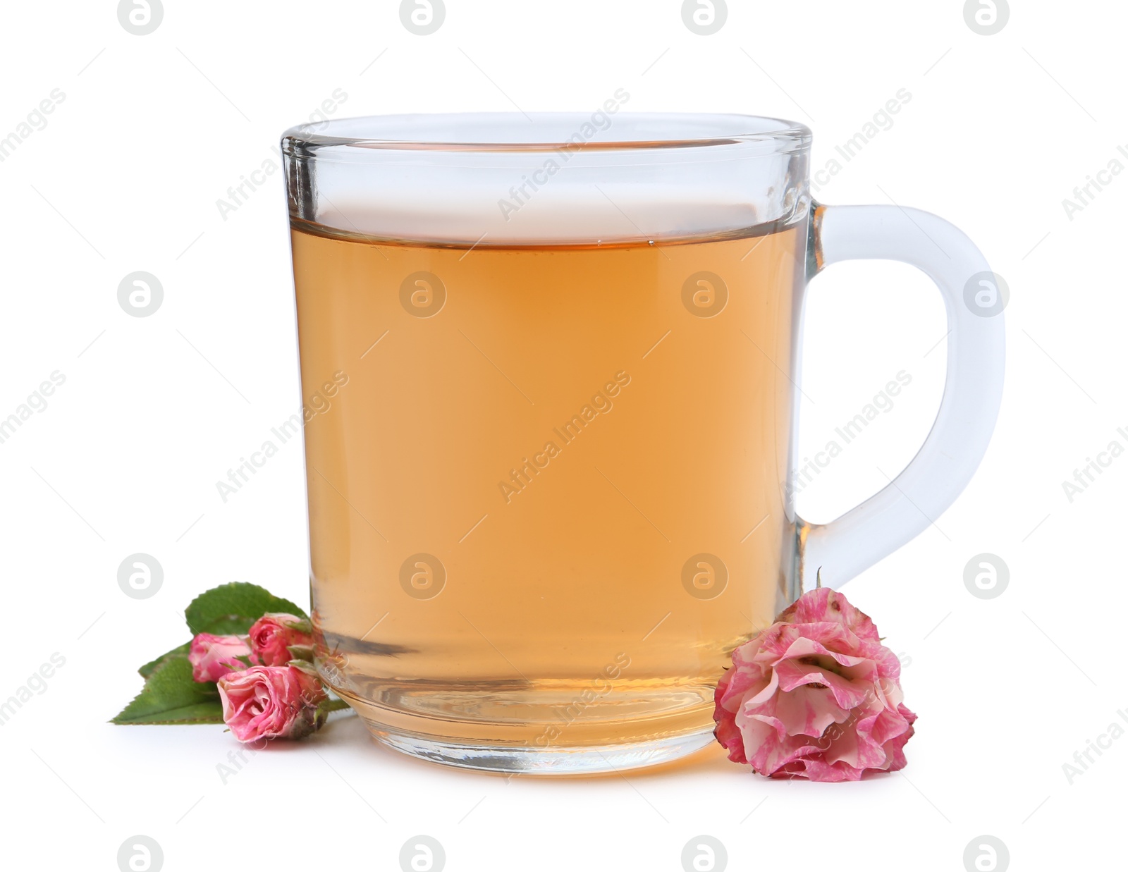 Aromatic tea in glass cup, roses and green leaves isolated on white Photo of Aromatic tea in glass cup, roses and green leaves isolated on white