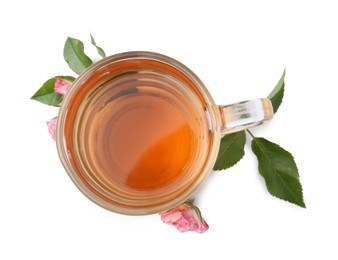 Photo of Aromatic tea in glass cup, roses and green leaves isolated on white, top view