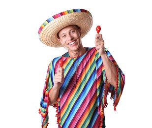 Photo of Smiling man in sombrero hat and colorful poncho playing maracas on white background