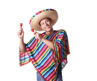Photo of Smiling man in sombrero hat and colorful poncho playing maracas on white background
