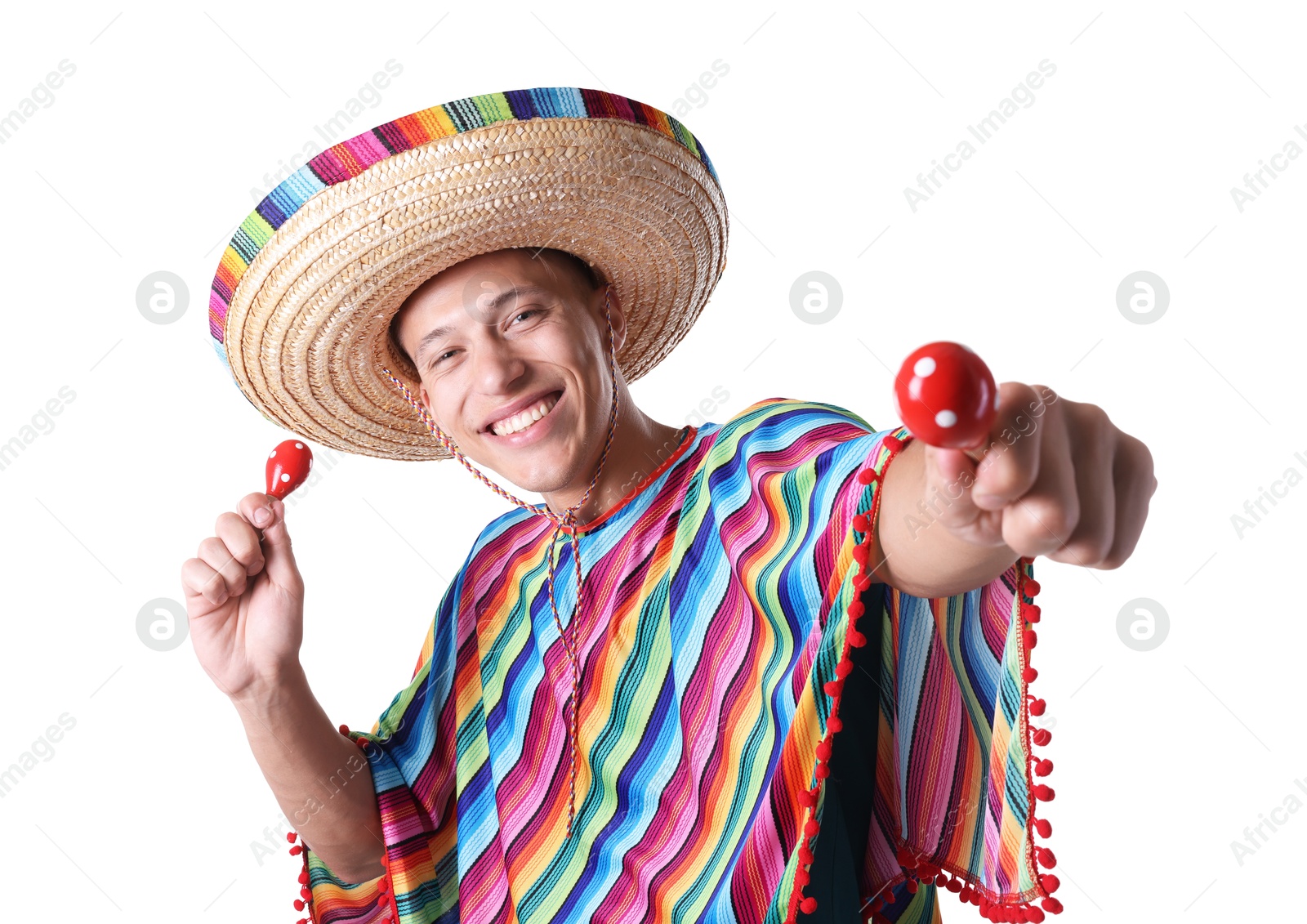 Photo of Smiling man in sombrero hat and colorful poncho with maracas on white background