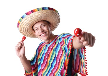 Photo of Smiling man in sombrero hat and colorful poncho with maracas on white background