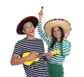 Photo of Happy couple in sombrero and Flamenco hats playing musical instruments on white background