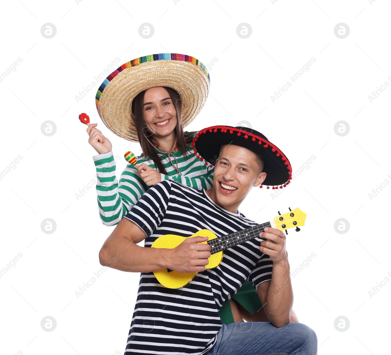 Photo of Happy couple in sombrero and Flamenco hats playing musical instruments on white background