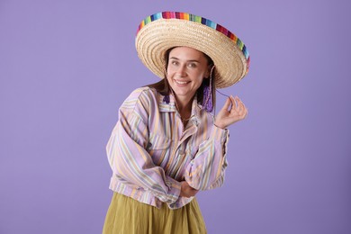 Photo of Smiling woman in sombrero hat on violet background