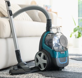 Photo of One vacuum cleaner on floor indoors. Household appliance
