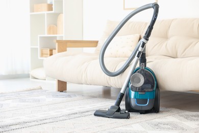 Photo of One vacuum cleaner on floor indoors. Household appliance