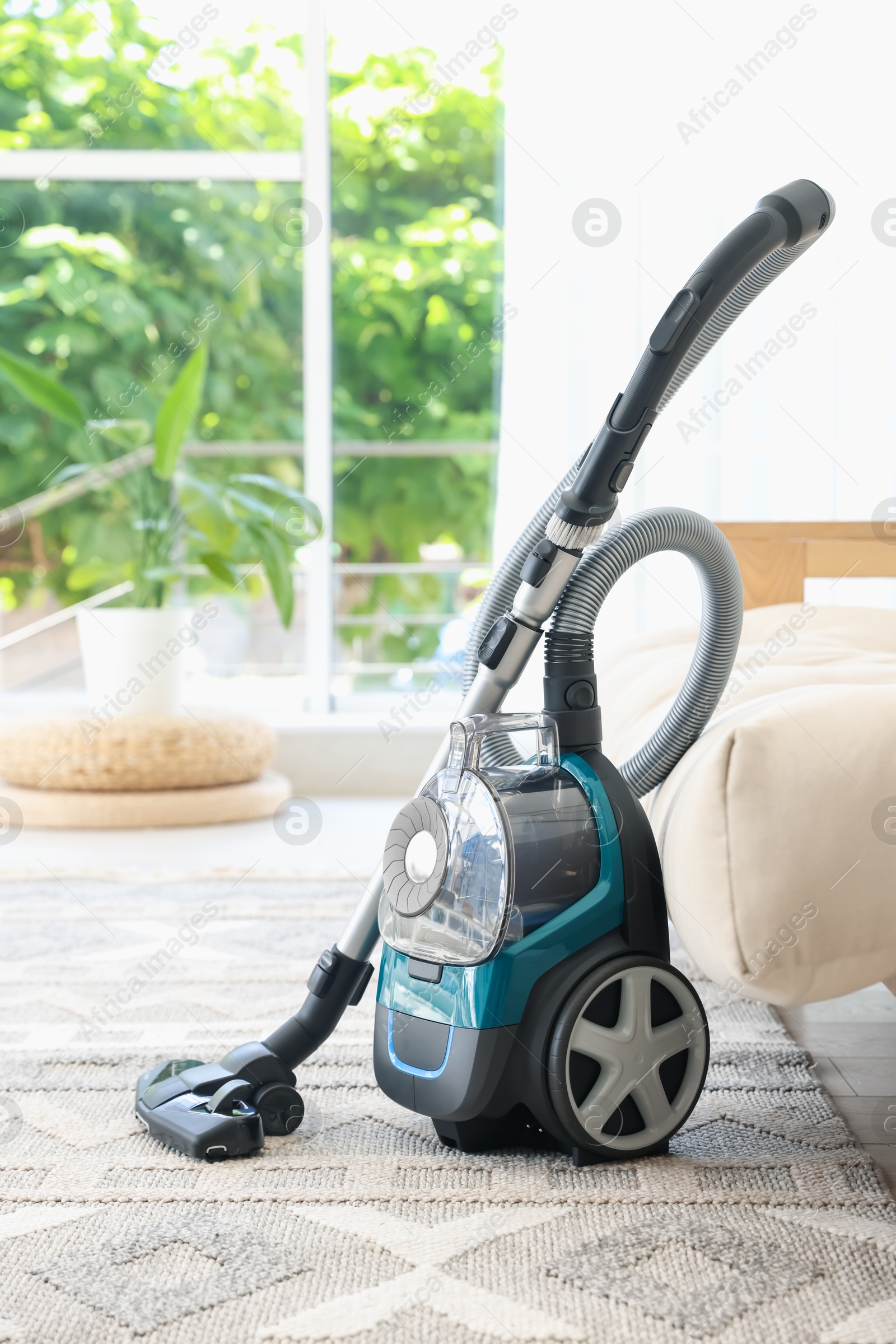 One vacuum cleaner on floor indoors. Household appliance Photo of One vacuum cleaner on floor indoors. Household appliance