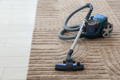 Photo of One vacuum cleaner on floor indoors. Household appliance
