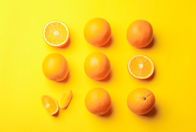 Photo of Fresh ripe oranges on yellow background, flat lay