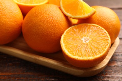 Photo of Fresh ripe oranges on wooden table, closeup