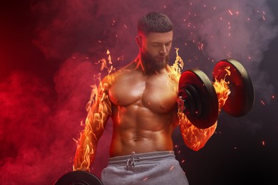 Image of Bodybuilder exercising with dumbbells in smoke against dark background. Muscular man with flaming arms