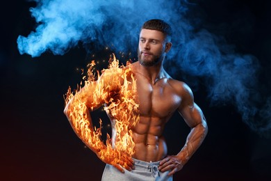 Image of Bodybuilder in smoke against black background. Muscular man with flaming body