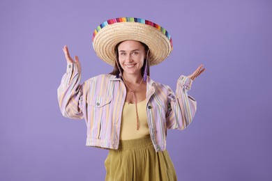 Photo of Smiling woman in sombrero hat on violet background