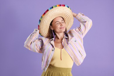 Photo of Beautiful woman in sombrero hat on violet background