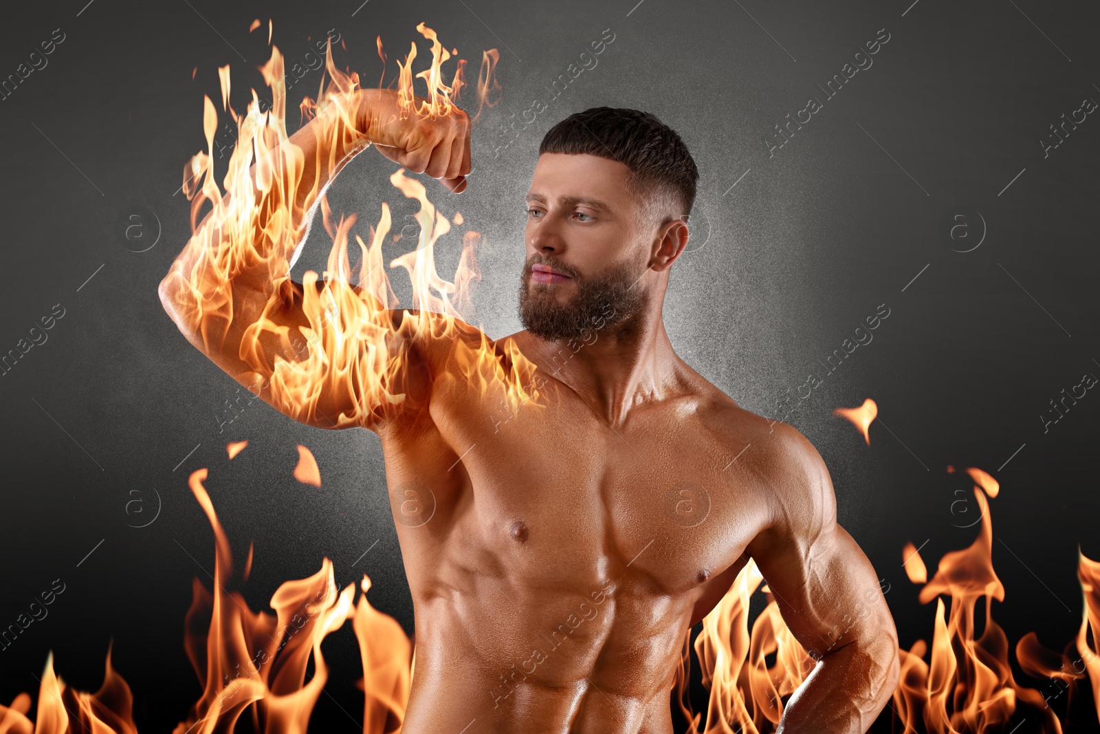 Bodybuilder showing his biceps against grey background. Muscular man with flaming arm and fire behind him Image of Bodybuilder showing his biceps against grey background. Muscular man with flaming arm and fire behind him