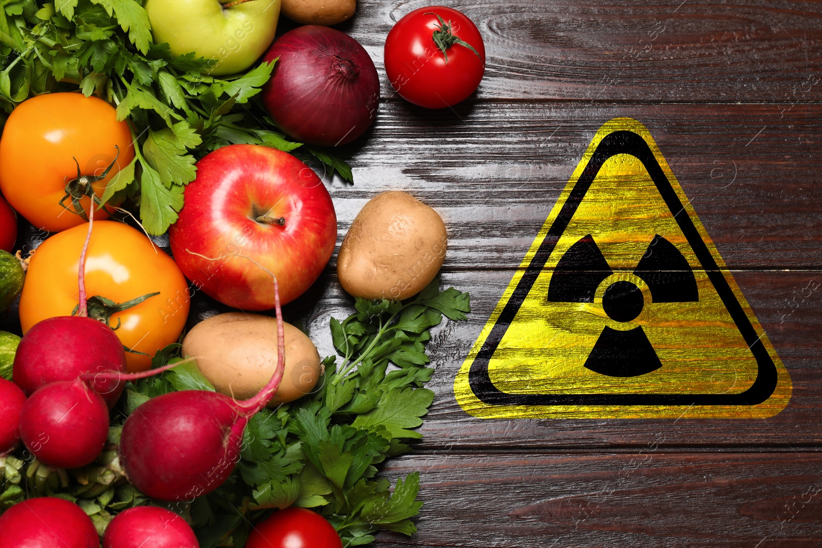 Fresh vegetables on wooden table and radioactive sign, top view. Environmental contamination, polluted food Image of Fresh vegetables on wooden table and radioactive sign, top view. Environmental contamination, polluted food