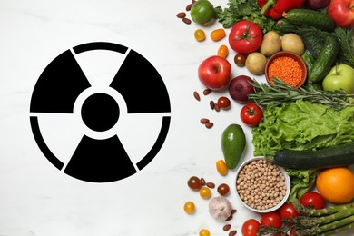 Image of Fresh vegetables, fruits and legumes on white marble table and radioactive sign, top view. Environmental contamination, polluted food