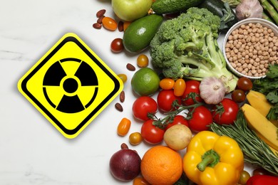 Image of Fresh vegetables, fruits and chickpea on white marble table and radioactive sign, top view. Environmental contamination, polluted food