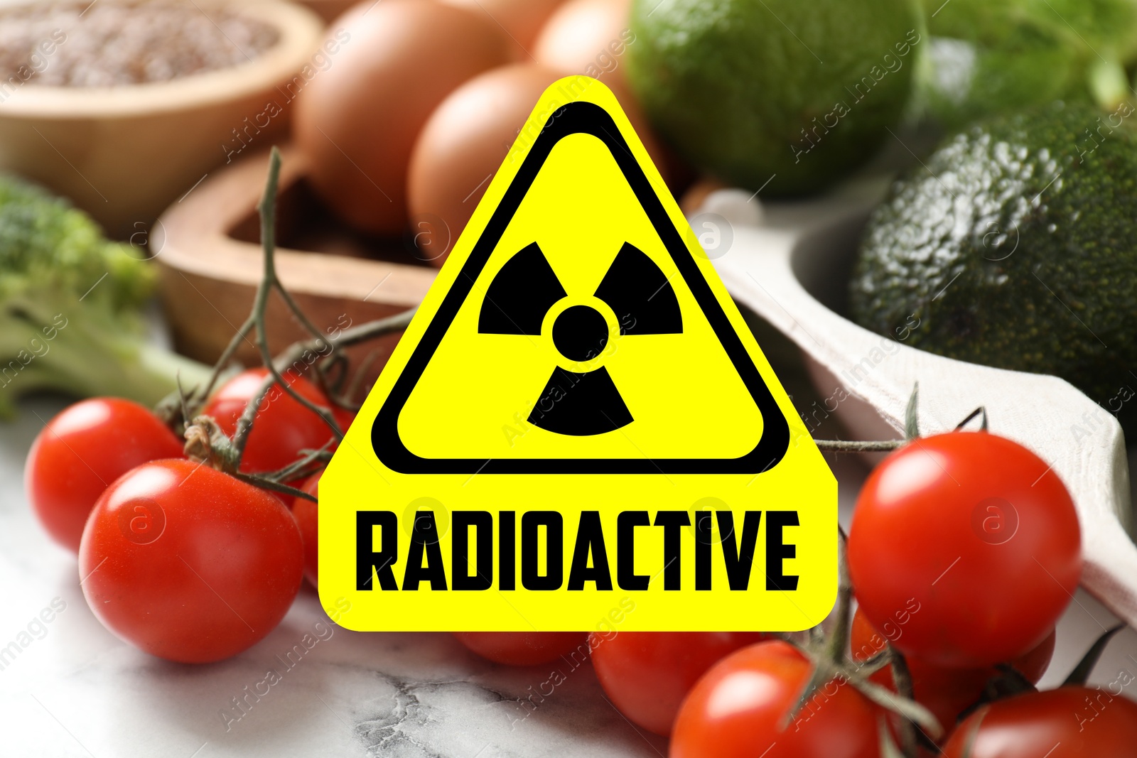 Image of Fresh vegetables on white marble table and radioactive sign. Environmental contamination, polluted food