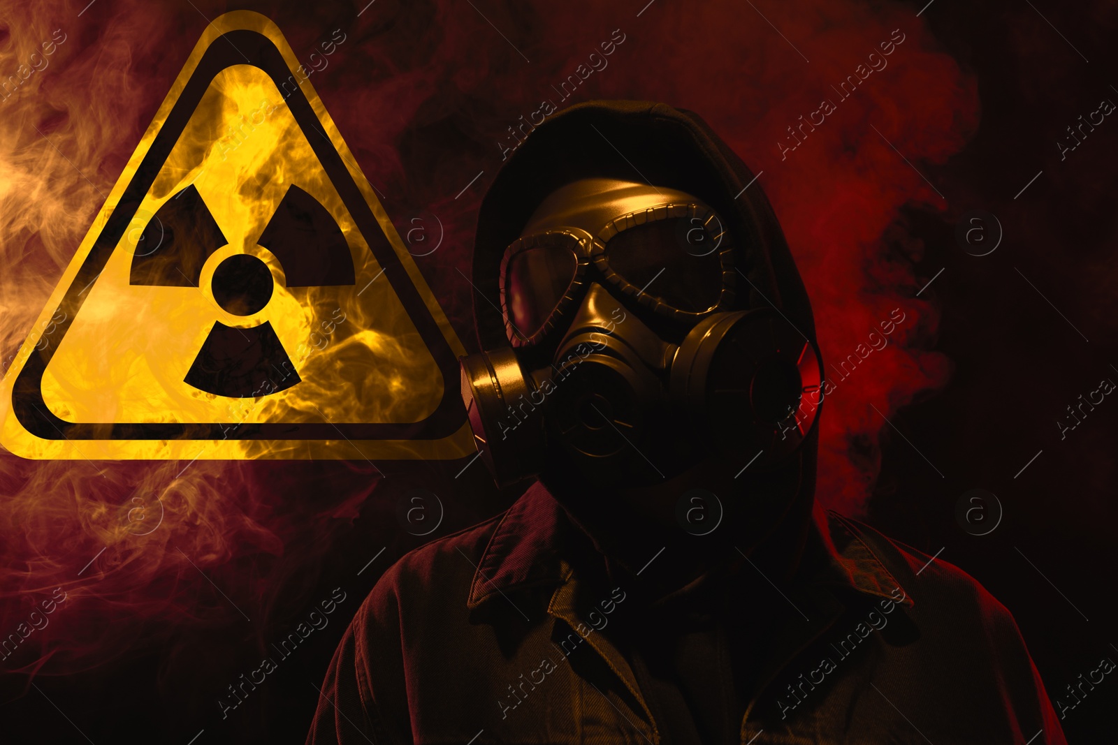 Man wearing gas mask in smoke against black background. Radioactive sign behind him Image of Man wearing gas mask in smoke against black background. Radioactive sign behind him