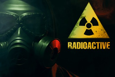 Image of Man wearing gas mask in smoke against black background. Radioactive sign near him