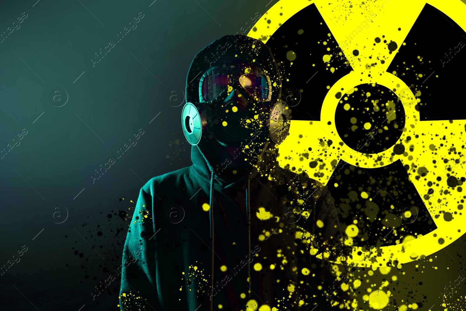 Image of Man wearing gas mask against dark background. Radioactive sign behind him