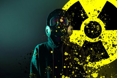Image of Man wearing gas mask against dark background. Radioactive sign behind him