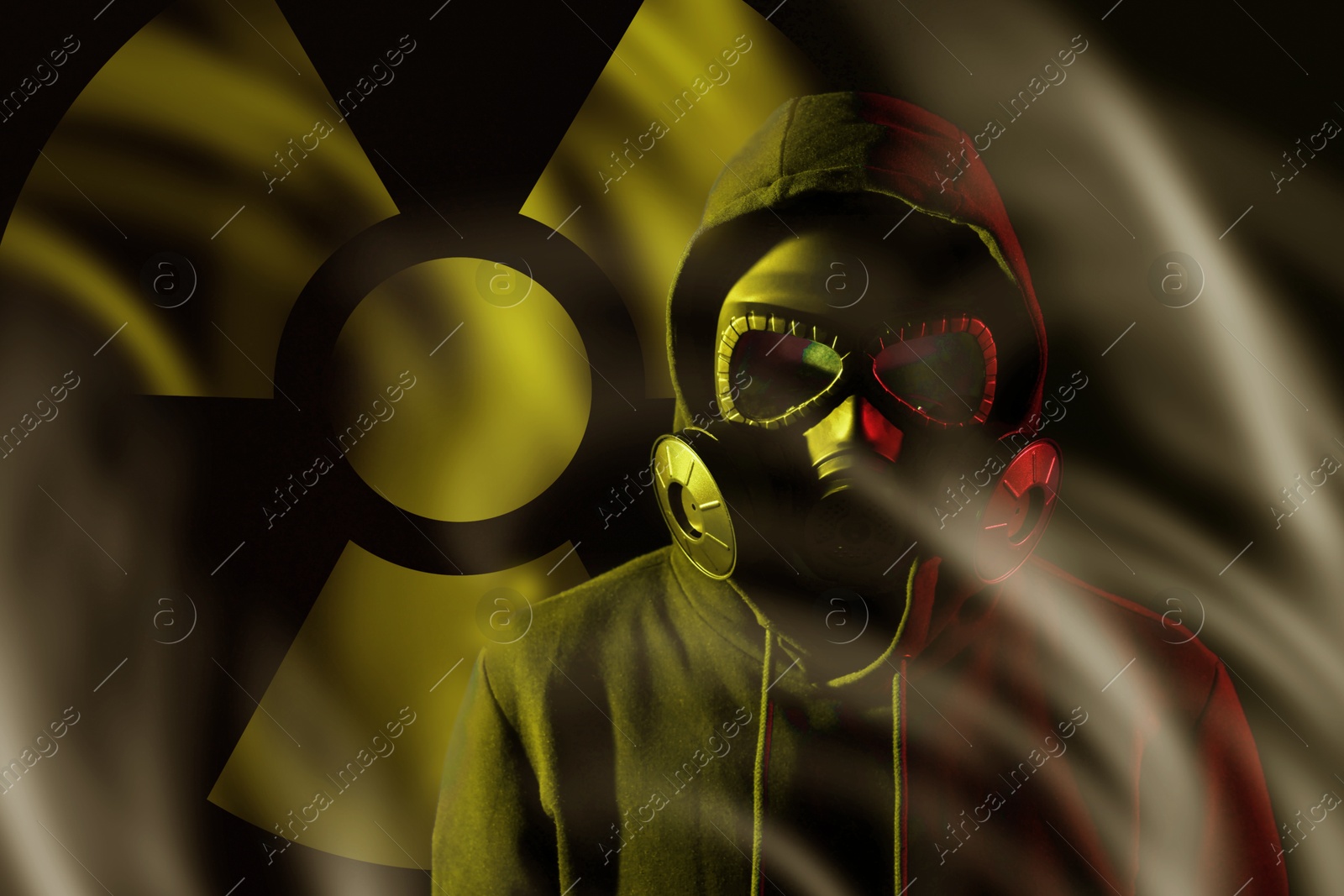 Man wearing gas mask in smoke against black background. Radioactive sign behind him Image of Man wearing gas mask in smoke against black background. Radioactive sign behind him