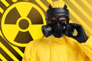 Image of Man wearing hazmat suit and gas mask against radioactive sign