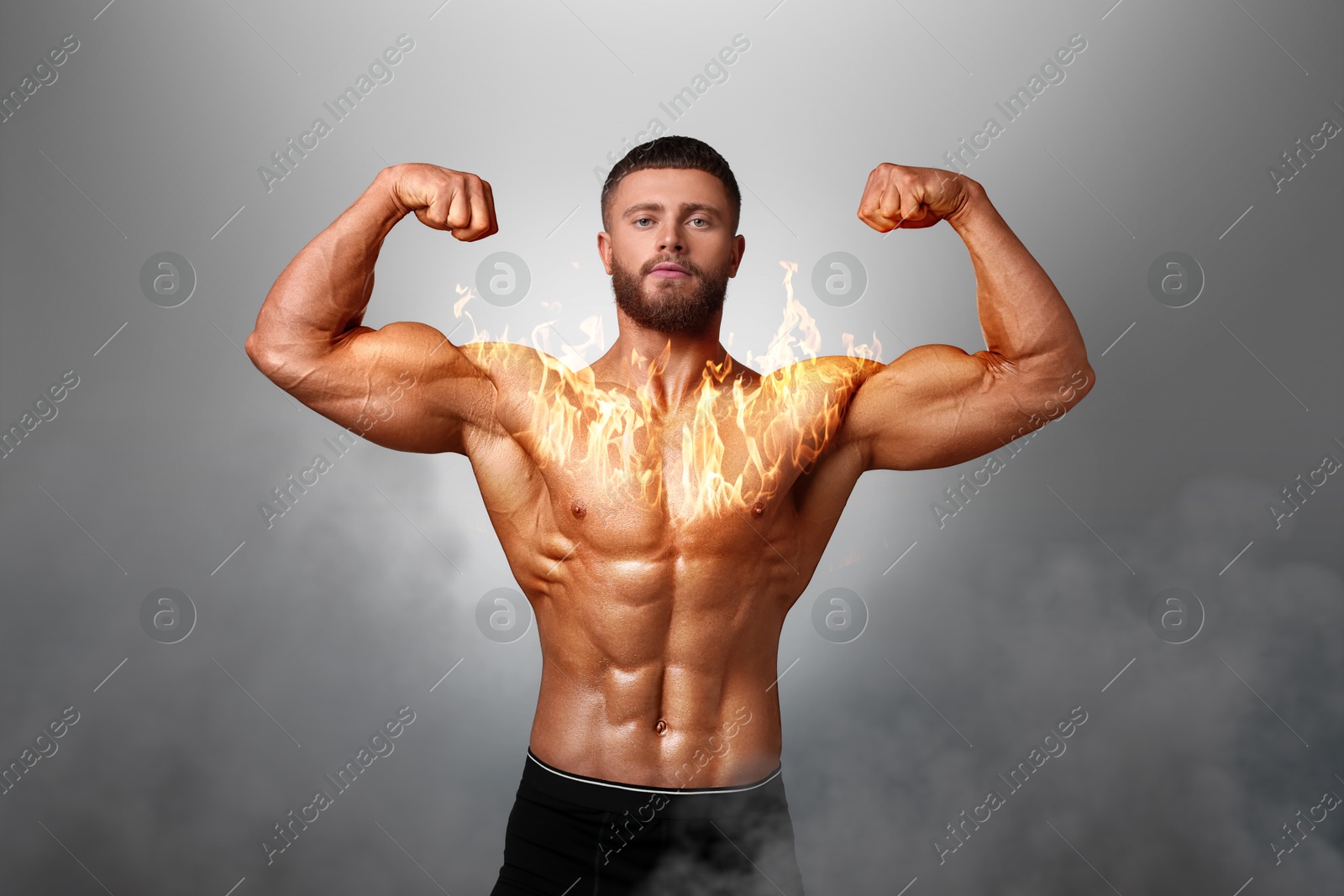 Image of Bodybuilder showing his biceps against grey background. Muscular man with flaming chest