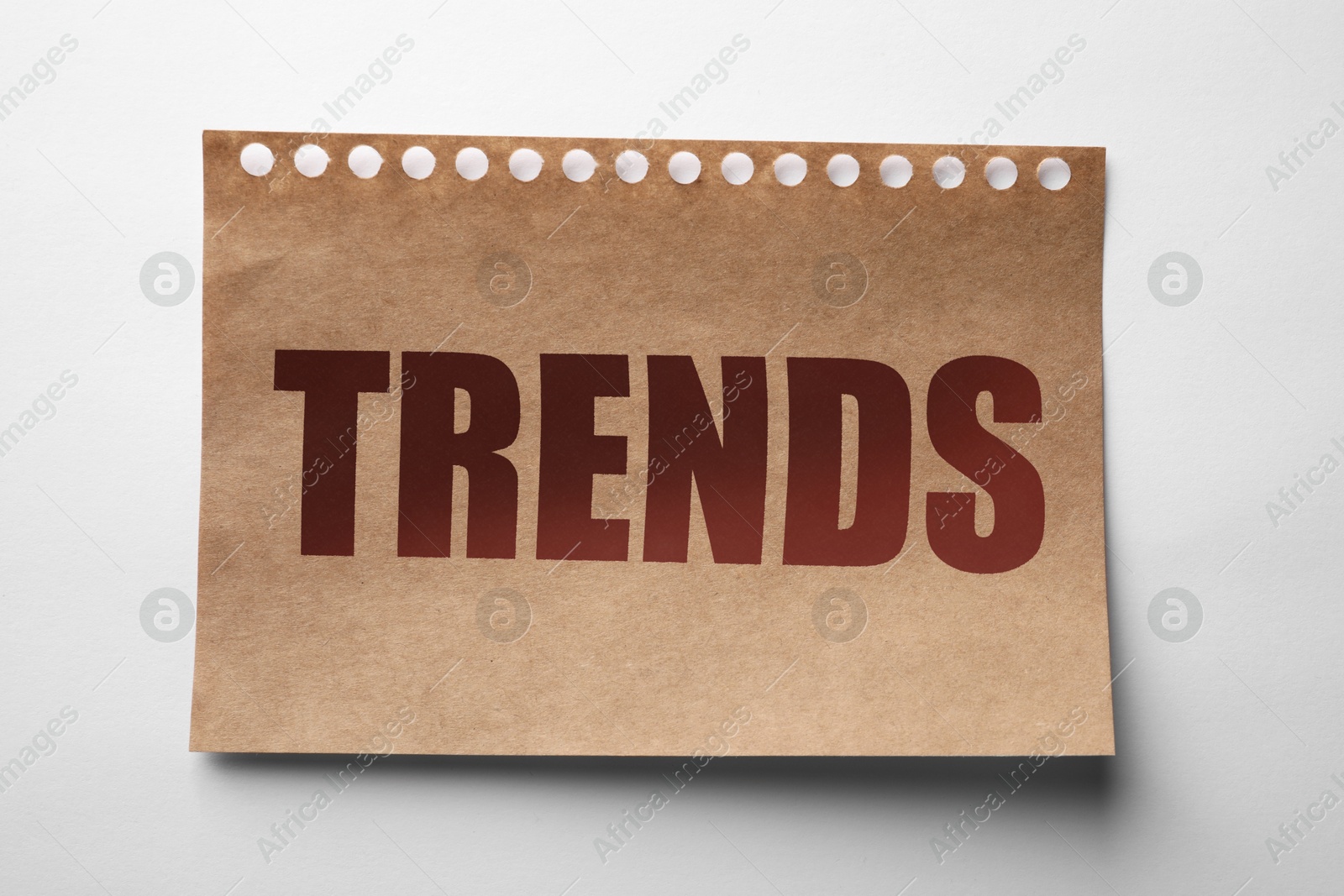 Image of Notebook sheet with word Trends on white background, top view