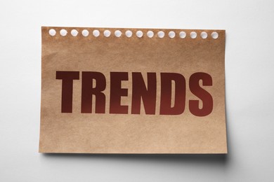 Image of Notebook sheet with word Trends on white background, top view