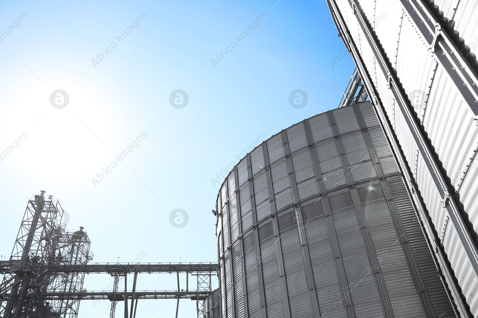 Modern granaries for storing cereal grains against blue sky, low angle view Image of Modern granaries for storing cereal grains against blue sky, low angle view