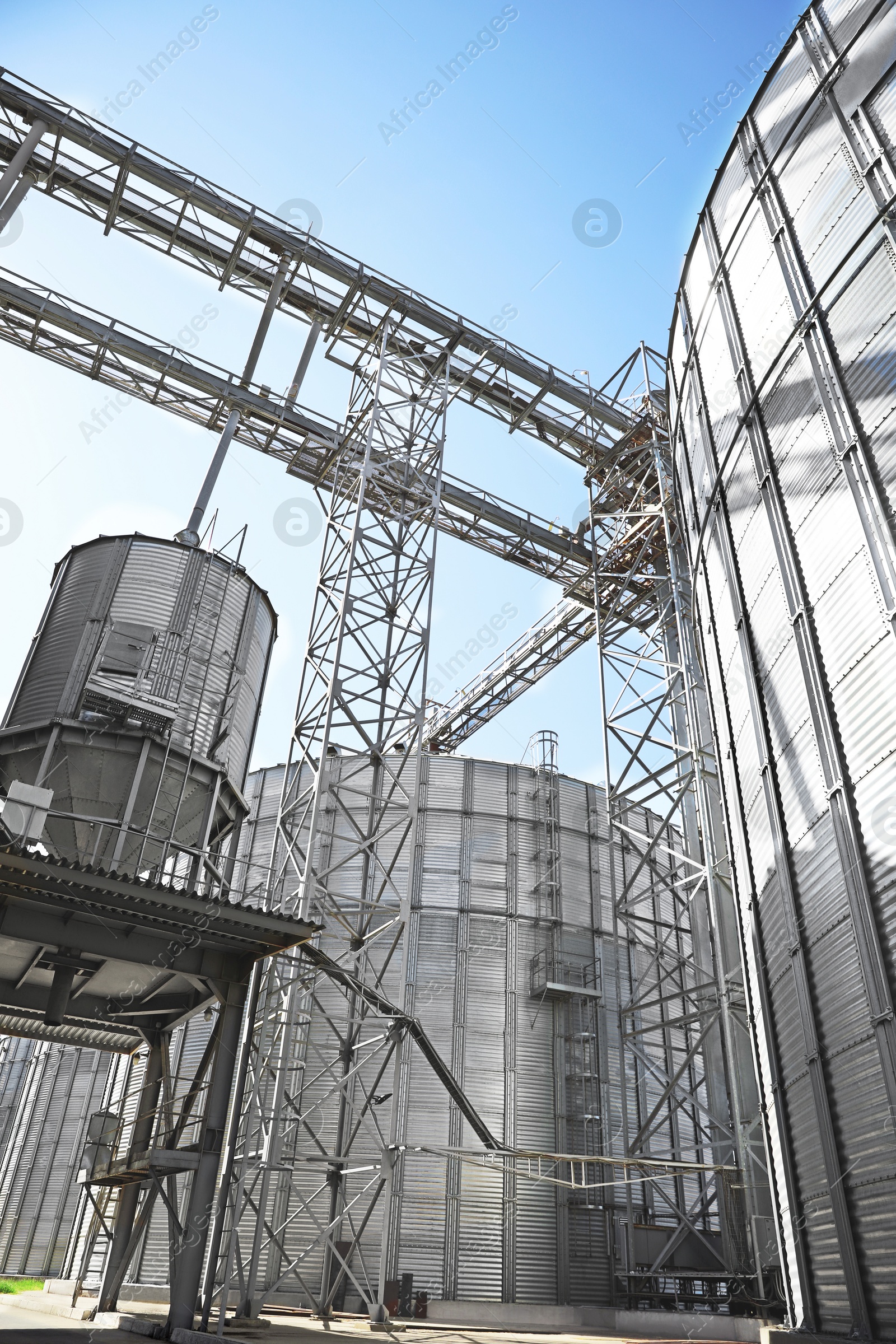 Modern granaries for storing cereal grains against blue sky, low angle view Image of Modern granaries for storing cereal grains against blue sky, low angle view