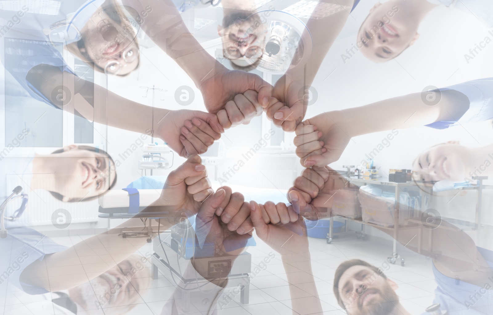 Doctors holding fists together and surgery room, double exposure. Banner design Image of Doctors holding fists together and surgery room, double exposure. Banner design