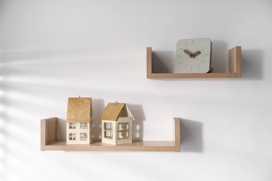 Photo of Wooden shelves with decor on white background